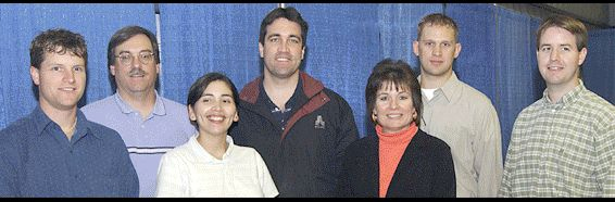 A young Alvarez, third from left, and Reynolds, far right, smile for a photo taken while they were both working in the propulsion systems department at Marshall.