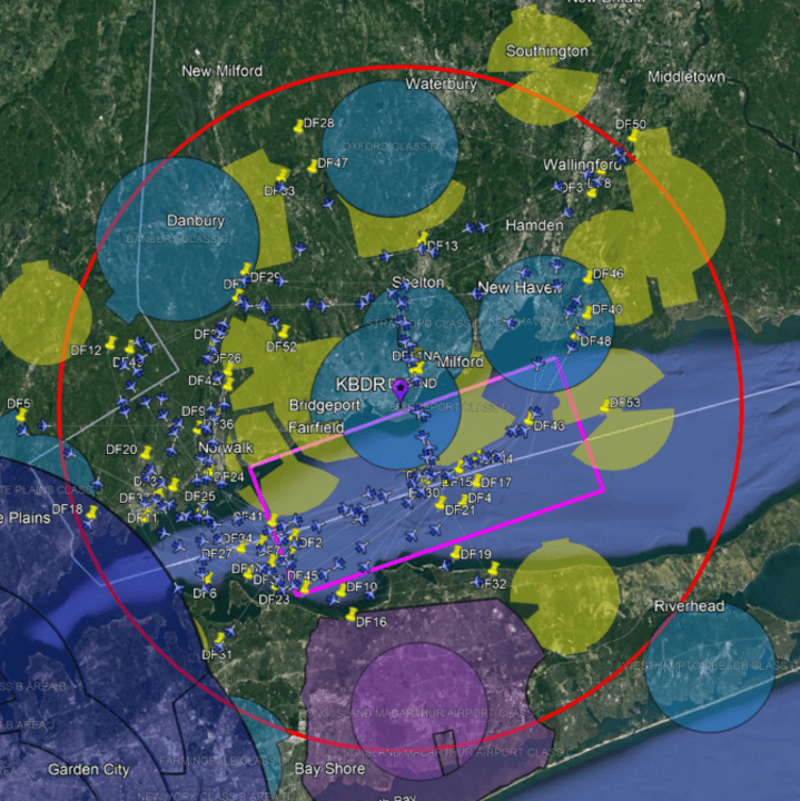 NASA researcher Stewart Nelson used flight path data from the Dallas-Fort Worth, Texas airspace to provide a mixed reality flight test zone over the airspace at the Sikorsky Memorial Airport in Bridgeport, Connecticut, and Port Jefferson Long Island, New York.   This map shows the Long Island Sound and the adjacent areas of Bridgeport, Connecticut, and Port Jefferson New York, with an overlay of the Dallas-Fort Worth, Texas airspace.    The large red circle represents a 25 nautical mile radius around the Sikorsky Memorial Airport in Bridgeport, Connecticut. Hundreds of virtual aircraft, representing background air traffic, are shown as small blue airplanes, flying in and out of a purple rectangle which is the perimeter of the flight test area. Vertiports, shown as yellow pushpins, represent locations for departures and arrivals for air taxis.   The yellow polygons represent commercial airspace operation which occur in the Dallas-Fort Worth airspace. The light blue circles denote Class D airspace allowing aircraft to fly up to 2500 feet in a radius of 4 nautical miles. The purple circles indicate Class C airspace which allows aircraft to fly up to 4,000 feet in a radius of 5 to 10 nautical miles. The dark blue circles at the bottom left of the image represent Class B controlled airspace, usually around the largest and busiest airports, where aircraft fly at 10,000 to 12,500 in a radius of 30 nautical miles.   These virtual airspace indicators provided the test pilots multiple scenarios to test the NASA software in a smaller flight environment.