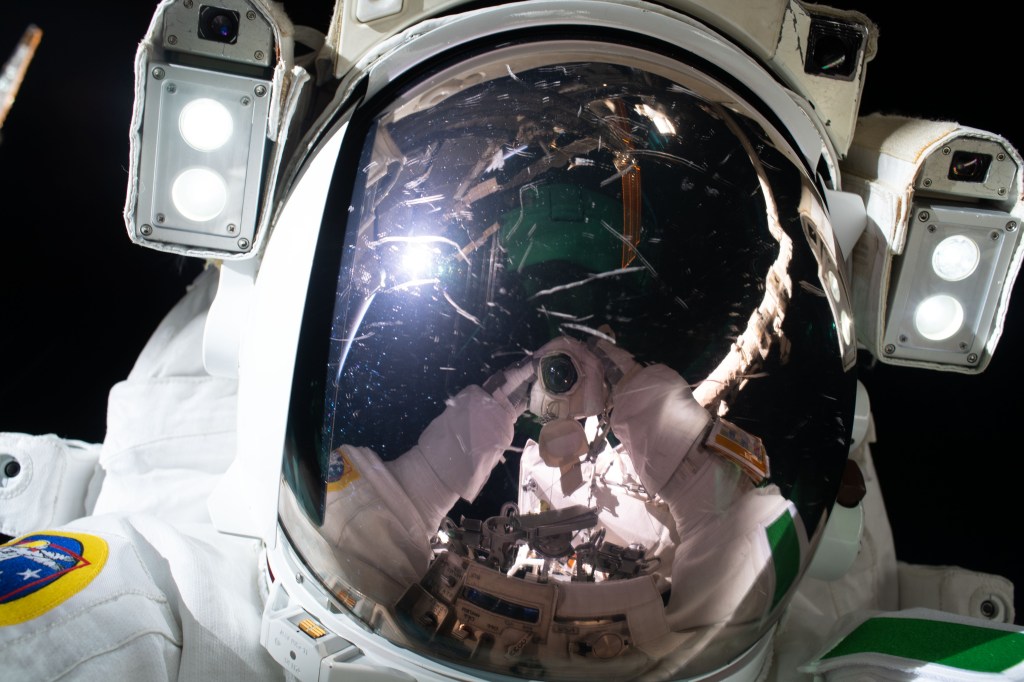 ESA (European Space Agency) astronaut Luca Parmitano takes a "space-selfie" with his camera's reflection on his spacesuit's helmet visor. He and NASA astronaut Andrew Morgan were finalizing thermal repairs on the Alpha Magnetic Spectrometer, a dark matter and antimatter detector, during a spacewalk that lasted 6 hours and 16 minutes.