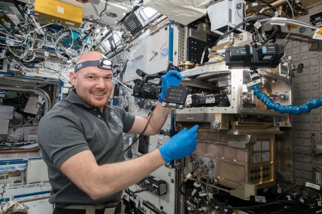 European Space Agency (ESA) astronaut Alexander Gerst configures the Light Microscopy Module (LMM) for the Advanced Colloids Experiment-Temperature-7 (ACE-T-7) experiment. ACE-T-7 involves the design and assembly of complex three-dimensional structures from small particles suspended within a fluid medium. These so-called “self-assembled colloidal structures”, are vital to the design of advanced optical materials and active devices. In the microgravity environment, insight is provided into the relation between particle shape and interparticle interactions on assembly structure and dynamics: fundamental issues in condensed matter science.