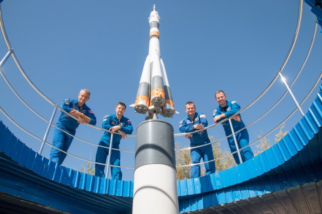 Expedition 57 backup and prime crew members pose for pictures flanking a model of a Soyuz rocket, Wednesday, Oct. 3, 2018 at the Cosmonaut Hotel crew quarters in Baikonur, Kazakhstan. From left are backup crew members David Saint-Jacques of the Canadian Space Agency and Oleg Kononenko of Roscosmos and prime crew members Alexey Ovchinin of Roscosmos and Nick Hague of NASA. Ovchinin and Hague are scheduled to launch on Oct. 11 onboard the Soyuz MS-10 spacecraft from the Baikonur Cosmodrome in Kazakhstan for a six-month mission on the International Space Station.