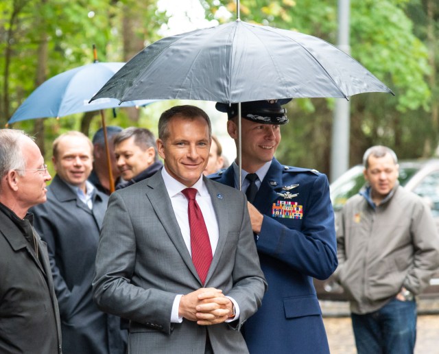 At the Gagarin Cosmonaut Training Center in Star City, Russia, Expedition 57 backup crew member David Saint-Jacques of the Canadian Space Agency arrives for departure ceremonies Sept. 25, shielded from the rain by prime crewmember Nick Hague of NASA. Hague and Alexey Ovchinin of Roscosmos will launch Oct. 11 from the Baikonur Cosmodrome in Kazakhstan on the Soyuz MS-10 spacecraft for a six-month mission on the International Space Station.