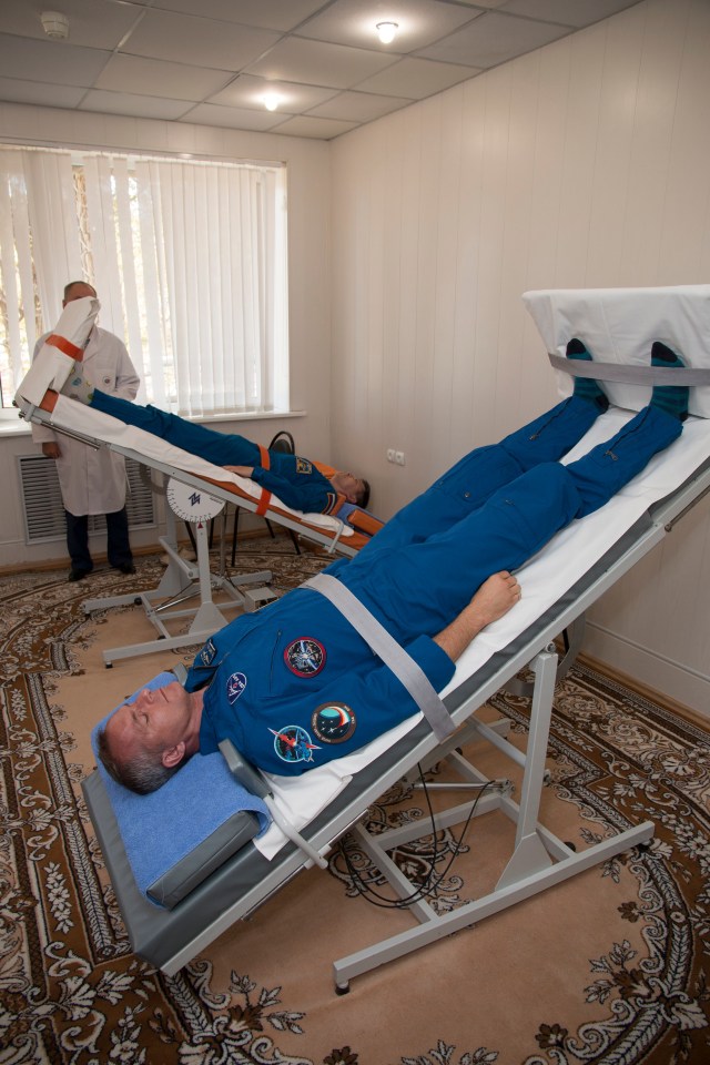 Expedition 57 backup crew members Oleg Kononenko of Roscosmos, top, and David Saint-Jacques of the Canadian Space Agency, bottom, conduct tests of their vestibular system on tilt tables, Wednesday, Oct. 3, 2018 at the Cosmonaut Hotel in Baikonur, Kazakhstan. Alexey Ovchinin of Roscosmos and Nick Hague of NASA are scheduled to launch on Oct. 11 onboard the Soyuz MS-10 spacecraft from the Baikonur Cosmodrome in Kazakhstan for a six-month mission on the International Space Station.