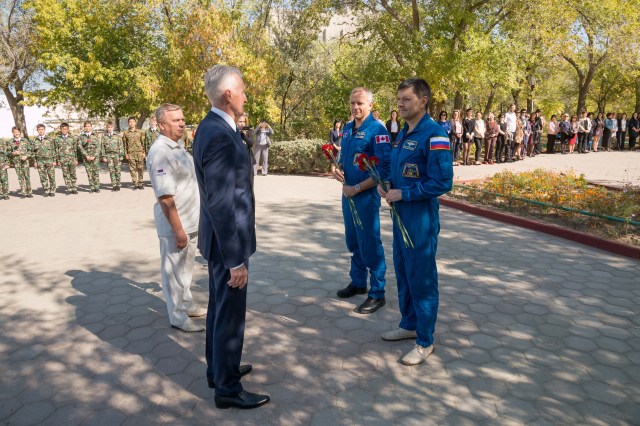 At their Cosmonaut Hotel crew quarters in Baikonur, Kazakhstan, Expedition 57 backup crew members David Saint-Jacques of the Canadian Space Agency and Oleg Kononenko of Roscosmos (right) present flowers to local officials Sept. 27 as part of traditional pre-launch ceremonies. They are the backups to the prime crew, Alexey Ovchinin of Roscosmos and Nick Hague of NASA, who will launch Oct. 11 on the Soyuz MS-10 spacecraft from the Baikonur Cosmodrome in Kazakhstan for a six-month mission on the International Space Station.