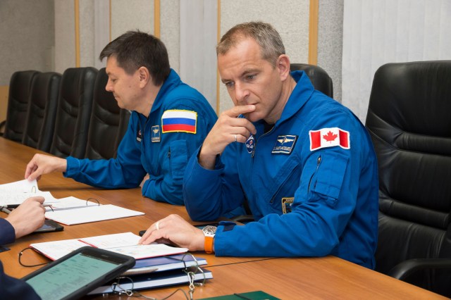 Expedition 57 backup crew members Oleg Kononenko of Roscosmos, left, and David Saint-Jacques of the Canadian Space Agency, right, review training documents with a Gagarin Cosmonaut Training Center instructor as they prepare for their upcoming launch, Wednesday, Oct. 3, 2018 at the Cosmonaut Hotel in Baikonur, Kazakhstan. Alexey Ovchinin of Roscosmos and Nick Hague of NASA are scheduled to launch on Oct. 11 onboard the Soyuz MS-10 spacecraft from the Baikonur Cosmodrome in Kazakhstan for a six-month mission on the International Space Station.