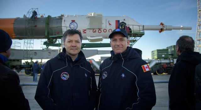 Expedition 57 backup crew members Oleg Kononenko of Roscosmos, left, and David Saint-Jacques of the Canadian Space Agency pose for a photograph by the Soyuz MS-10 spacecraft after it rolled out to the launch pad, Tuesday, Oct. 9, 2018 at the Baikonur Cosmodrome in Kazakhstan. Expedition 57 crewmembers Nick Hague of NASA and Alexey Ovchinin of Roscosmos are scheduled to launch on October 11 and will spend the next six months living and working aboard the International Space Station.