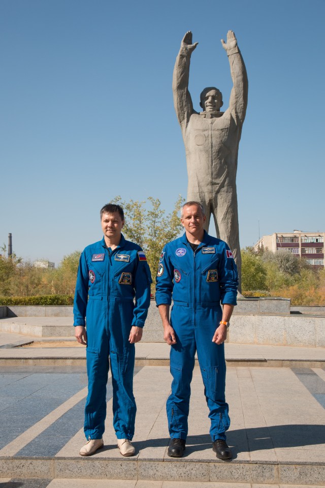 During a tour of the city of Baikonur, Kazakhstan, Expedition 57 backup crew members Oleg Kononenko of Roscosmos (left) and David Saint-Jacques of the Canadian Space Agency (right) pose for pictures Sept. 27 at the statue of Yuri Gagarin, the first human to fly in space, during traditional pre-launch ceremonies. They are the backups to the prime crew, Alexey Ovchinin of Roscosmos and Nick Hague of NASA, who will launch Oct. 11 on the Soyuz MS-10 spacecraft from the Baikonur Cosmodrome in Kazakhstan for a six-month mission on the International Space Station.