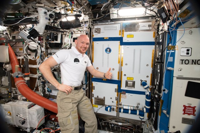 Expedition 57 Commander Alexander Gerst of ESA (European Space Agency), surrounded by exercise and science gear inside the U.S. Destiny laboratory, gives a thumbs up sign after completing maintenance work on a Life Support Rack.