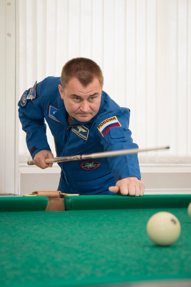 Expedition 57 crew member Alexey Ovchinin of Roscosmos plays a game of billiards as part of the traditional pre-launch activities, Wednesday, Oct. 3, 2018 at the Cosmonaut Hotel in Baikonur, Kazakhstan. Ovchinin and Nick Hague of NASA are scheduled to launch on Oct. 11 onboard the Soyuz MS-10 spacecraft from the Baikonur Cosmodrome in Kazakhstan for a six-month mission on the International Space Station.