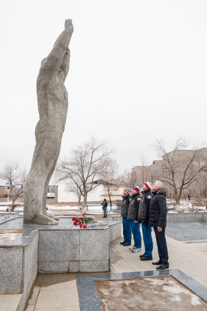 Joined by a local official in the town of Baikonur, Kazakhstan, Expedition 59 backup crew members Drew Morgan of NASA, Alexander Skvortsov of Roscosmos and Luca Parmitano of the European Space Agency participate in ceremonies at the statue of Yuri Gagarin, the first human to fly in space, as part of traditional pre-launch activities Feb. 28. They are the backups to Nick Hague and Christina Koch of NASA and Alexey Ovchinin of Roscosmos, who will launch March 14, U.S. time, in the Soyuz MS-12 spacecraft from the Baikonur Cosmodrome in Kazakhstan for a six-and-a-half month mission on the International Space Station.