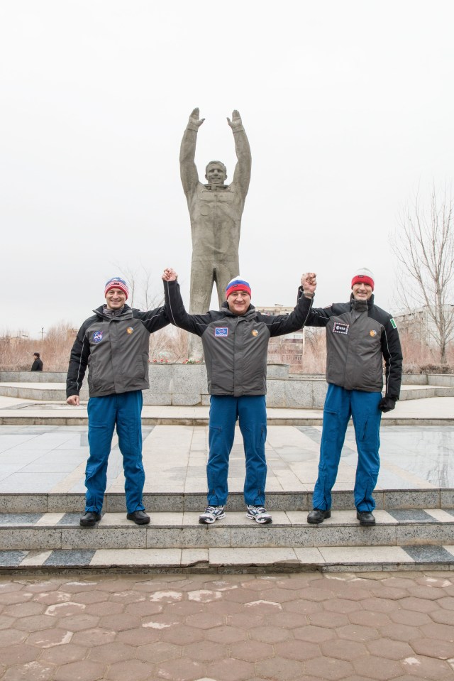 In the town of Baikonur, Kazakhstan, Expedition 59 backup crew members Drew Morgan of NASA (left), Alexander Skvortsov of Roscosmos (center) and Luca Parmitano of the European Space Agency (right) pose for pictures at the statue of Yuri Gagarin, the first human to fly in space, during traditional pre-launch activities Feb. 28. They are the backups to Nick Hague and Christina Koch of NASA and Alexey Ovchinin of Roscosmos, who will launch March 14, U.S. time, in the Soyuz MS-12 spacecraft from the Baikonur Cosmodrome in Kazakhstan for a six-and-a-half month mission on the International Space Station.