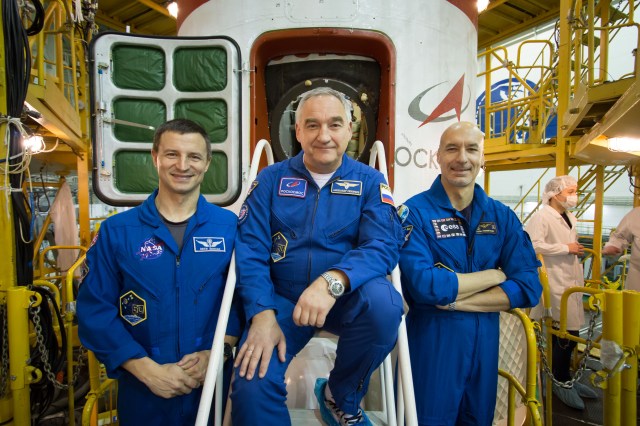 In the Integration Building at the Baikonur Cosmodrome in Kazakhstan, Expedition 59 backup crew members Drew Morgan of NASA (left), Alexander Skvortsov of Roscosmos (center) and Luca Parmitano of the European Space Agency (right) pose for pictures in front of the Soyuz MS-12 spacecraft March 10 during final pre-launch inspections. They are the backups to the prime crew members, Nick Hague and Christina Koch of NASA and Alexey Ovchinin of Roscosmos, who will launch March 14, U.S. time, in the Soyuz MS-12 spacecraft from the Baikonur Cosmodrome for a six-and-a-half month mission on the International Space Station.