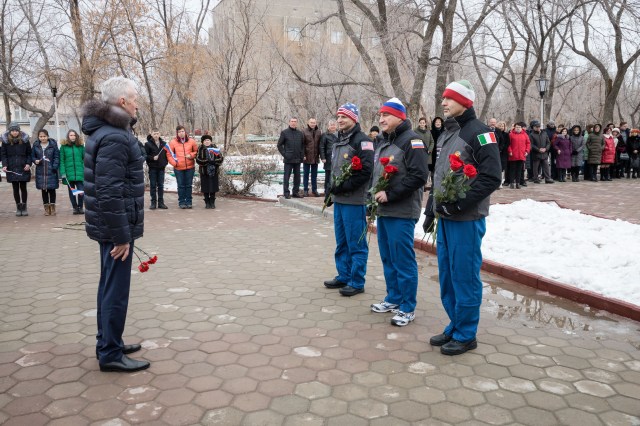 In the town of Baikonur, Kazakhstan, Expedition 59 backup crew members Drew Morgan of NASA (left), Alexander Skvortsov of Roscosmos (center) and Luca Parmitano of the European Space Agency (right) prepare to lay flowers at the statue of Yuri Gagarin, the first human to fly in space, during traditional pre-launch activities Feb. 28. They are the backups to Nick Hague and Christina Koch of NASA and Alexey Ovchinin of Roscosmos, who will launch March 14, U.S. time, in the Soyuz MS-12 spacecraft from the Baikonur Cosmodrome in Kazakhstan for a six-and-a-half month mission on the International Space Station.