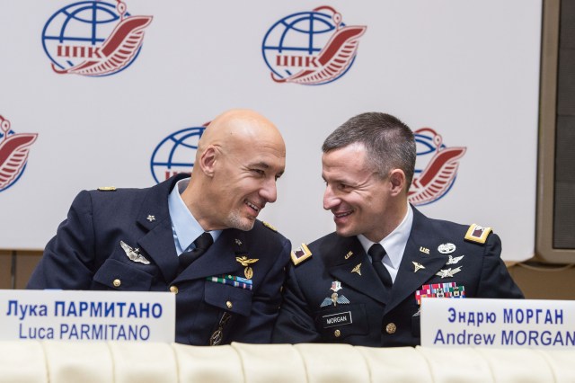 At the Gagarin Cosmonaut Training Center in Star City, Russia, Expedition 59 backup crew members Luca Parmitano of the European Space Agency (left) and Drew Morgan of NASA (right) exchange thoughts Feb. 21 during a pre-launch news conference. They and Alexander Skvortsov of Roscosmos are backups to the prime crewmembers, Nick Hague and Christina Koch of NASA and Alexey Ovchinin of Roscosmos, who will launch March 14, U.S. time, on the Soyuz MS-12 spacecraft from the Baikonur Cosmodrome in Kazakhstan for a six-and-a-half month mission on the International Space Station.