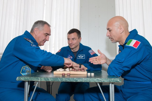 At their Cosmonaut Hotel crew quarters in Baikonur, Kazakhstan, Expedition 59 backup crew members Alexander Skvortsov of Roscosmos (left), Drew Morgan of NASA (center) and Luca Parmitano of the European Space Agency (right) take a moment from pre-launch training for a game of chess March 7. They are the backups to the prime crew members, Christina Koch of NASA, Alexey Ovchinin of Roscosmos and Nick Hague of NASA, who will launch March 14, U.S. time, on the Soyuz MS-12 spacecraft from the Baikonur Cosmodrome for a six-and-a-half month mission on the International Space Station.