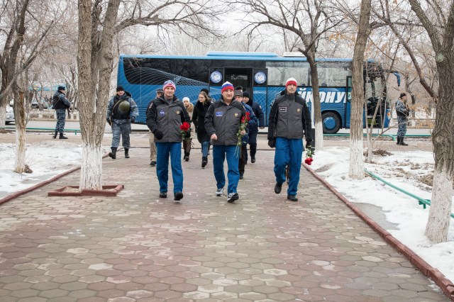 In the town of Baikonur, Kazakhstan, Expedition 59 backup crew members Drew Morgan of NASA (left), Alexander Skvortsov of Roscosmos (center) and Luca Parmitano of the European Space Agency (right) prepare to lay flowers at the statue of Yuri Gagarin, the first human to fly in space, during traditional pre-launch activities Feb. 28. They are the backups to Nick Hague and Christina Koch of NASA and Alexey Ovchinin of Roscosmos, who will launch March 14, U.S. time, in the Soyuz MS-12 spacecraft from the Baikonur Cosmodrome in Kazakhstan for a six-and-a-half month mission on the International Space Station.