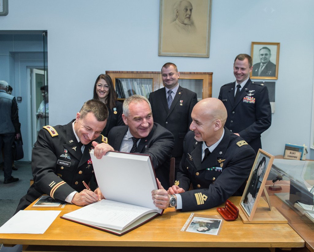 At the Gagarin Museum in the Gagarin Cosmonaut Training Center in Star City, Russia, Expedition 59 backup crew member Drew Morgan of NASA (front, left) signs a ceremonial book Feb. 21 as his crewmates, Alexander Skvortsov of Roscosmos (center) and Luca Parmitano of the European Space Agency (right) look on. In the back row are the prime crewmembers, Christina Koch of NASA, Alexey Ovchinin of Roscosmos and Nick Hague of NASA, who will launch March 14, U.S. time, on the Soyuz MS-12 spacecraft from the Baikonur Cosmodrome in Kazakhstan for a six-and-a-half month mission on the International Space Station.