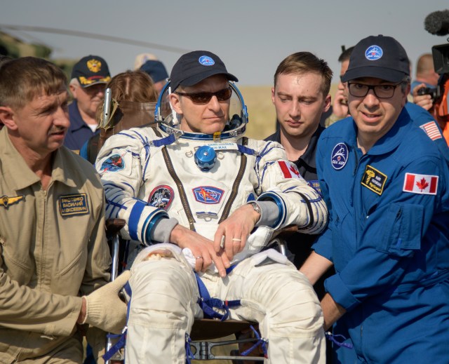 Expedition 59 Canadian Space Agency astronaut David Saint-Jacques is carried to a medical tent shortly after he, NASA astronaut Anne McClain, and Roscosmos cosmonaut Oleg Kononenko landed in their Soyuz MS-11 spacecraft near the town of Zhezkazgan, Kazakhstan on Tuesday, June 25, 2019 Kazakh time (June 24 Eastern time). McClain, Saint-Jacques, and Kononenko are returning after 204 days in space where they served as members of the Expedition 58 and 59 crews onboard the International Space Station.