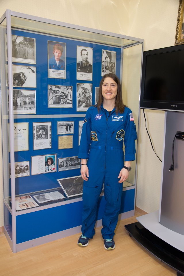 At the Baikonur Cosmodrome in Kazakhstan, Expedition 59 crew member Christina Koch of NASA poses for pictures March 10 in front of a display housing memorabilia from the flight of the first woman to fly in space, Valentina Tereshkova, whose historic mission took place in June 1963. Koch, Nick Hague of NASA and Alexey Ovchinin of Roscosmos will launch March 14, U.S. time, in the Soyuz MS-12 spacecraft from the Baikonur Cosmodrome for a six-and-a-half month mission on the International Space Station.
