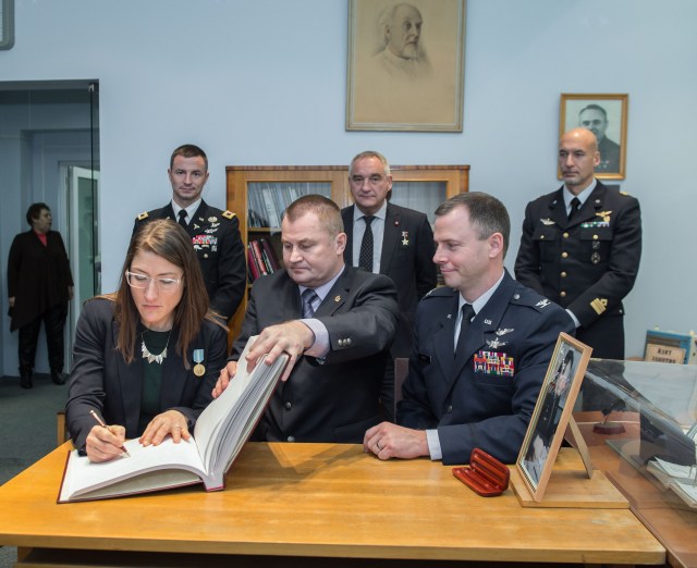 At the Gagarin Museum in the Gagarin Cosmonaut Training Center in Star City, Russia, Expedition 59 crew member Christina Koch of NASA (front, left) signs a ceremonial book Feb. 21 as part of the crew’s pre-launch activities as her crewmates, Alexey Ovchinin of Roscosmos (center) and Nick Hague of NASA (right) look on. In the back row are their backups, Drew Morgan of NASA, Alexander Skvortsov of Roscosmos and Luca Parmitano of the European Space Agency. Koch, Hague and Ovchinin will launch March 14, U.S. time, on the Soyuz MS-12 spacecraft from the Baikonur Cosmodrome in Kazakhstan for a six-and-a-half month mission on the International Space Station.
