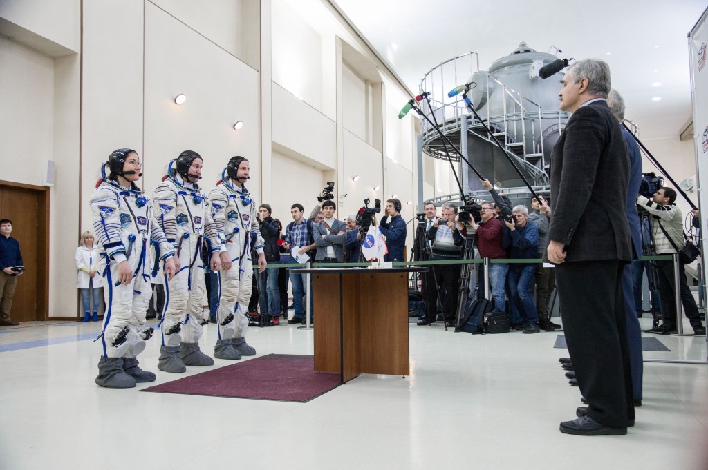 At the Gagarin Cosmonaut Training Center in Star City, Russia, Expedition 59 crew members Christina Koch of NASA (left), Alexey Ovchinin of Roscosmos (center) and Nick Hague of NASA (right) report to Russian space officials Feb. 20 during the second day of final pre-launch qualifications exams. They will launch March 14, U.S. time, in the Soyuz MS-12 spacecraft from the Baikonur Cosmodrome in Kazakhstan for a six-and-a-half month mission on the International Space Station.
