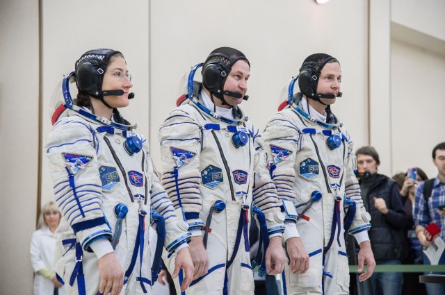 At the Gagarin Cosmonaut Training Center in Star City, Russia, Expedition 59 crew members Christina Koch of NASA (left), Alexey Ovchinin of Roscosmos (center) and Nick Hague of NASA (right) report to Russian space officials Feb. 20 during the second day of final pre-launch qualifications exams. They will launch March 14, U.S. time, in the Soyuz MS-12 spacecraft from the Baikonur Cosmodrome in Kazakhstan for a six-and-a-half month mission on the International Space Station.