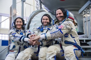 At the Gagarin Cosmonaut Training Center in Star City, Russia, Expedition 59 crew members Christina Koch of NASA (left), Alexey Ovchinin of Roscosmos (center) and Nick Hague of NASA (right) pose for pictures in front of their Soyuz spacecraft simulator Feb. 20 during the second day of final pre-launch qualifications exams. They will launch March 14, U.S. time, in the Soyuz MS-12 spacecraft from the Baikonur Cosmodrome in Kazakhstan for a six-and-a-half month mission on the International Space Station.