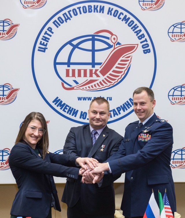 At the Gagarin Cosmonaut Training Center in Star City, Russia, Expedition 59 crew members Christina Koch of NASA (left), Alexey Ovchinin of Roscosmos (center) and Nick Hague of NASA (right) pose for pictures Feb. 21 following a pre-launch news conference. They will launch March 14, U.S. time, on the Soyuz MS-12 spacecraft from the Baikonur Cosmodrome in Kazakhstan for a six-and-a-half month mission on the International Space Station.