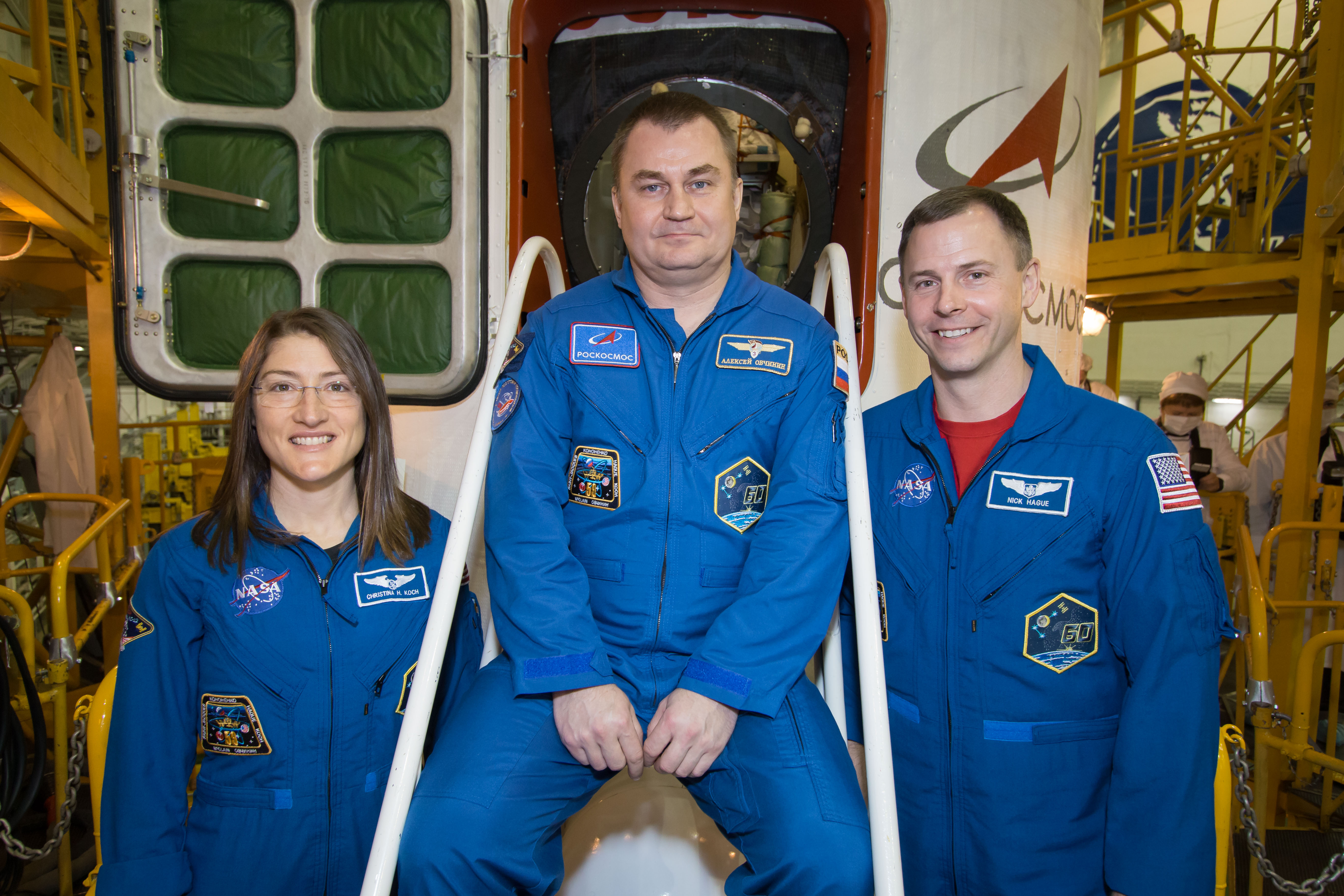 In the Integration Building at the Baikonur Cosmodrome in Kazakhstan, Expedition 59 crew members Christina Koch of NASA (left), Alexey Ovchinin of Roscosmos (center) and Nick Hague of NASA (right) pose for pictures in front of the Soyuz MS-12 spacecraft March 10 during final pre-launch inspections. They will launch March 14, U.S. time, in the Soyuz MS-12 spacecraft from the Baikonur Cosmodrome for a six-and-a-half month mission on the International Space Station.