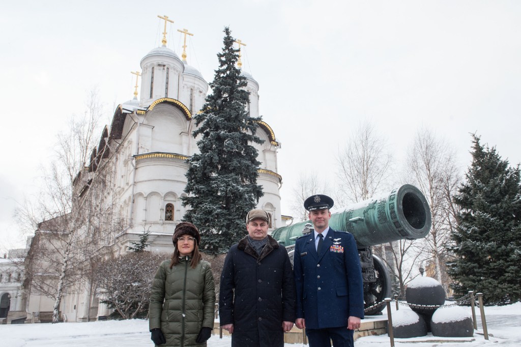 Inside the Kremlin in Moscow, Expedition 59 crew members Christina Koch of NASA (left), Alexey Ovchinin of Roscosmos (center) and Nick Hague of NASA (right) pose for pictures in front of the Tsar Cannon on a wintry day Feb. 21 as part of their pre-launch activities. They will launch March 14, U.S. time, on the Soyuz MS-12 spacecraft from the Baikonur Cosmodrome in Kazakhstan for a six-and-a-half month mission on the International Space Station.