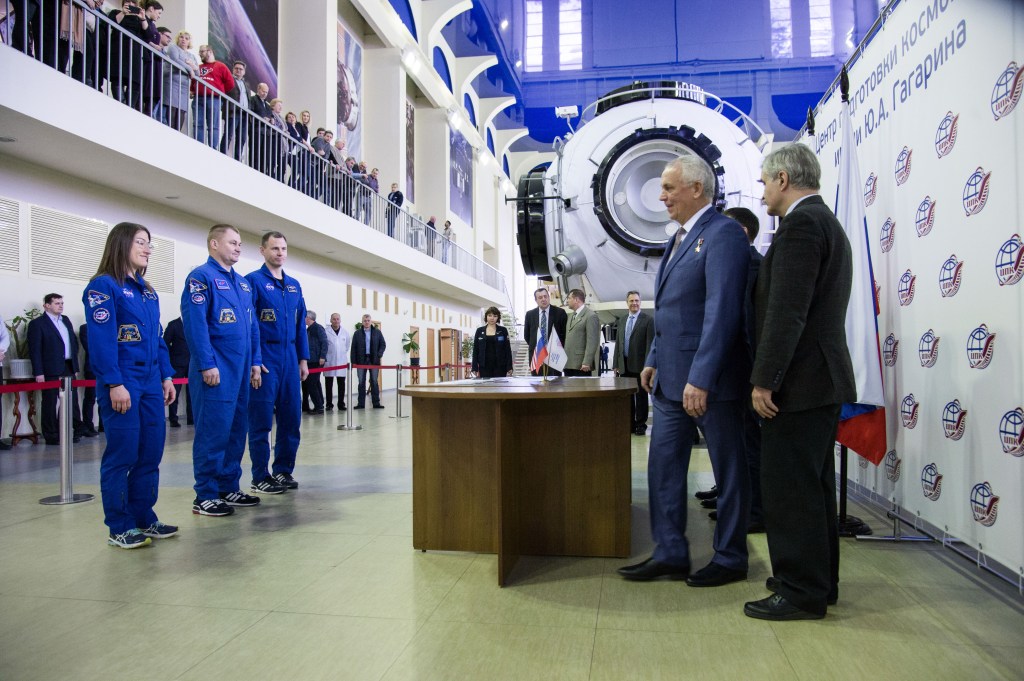 At the Gagarin Cosmonaut Training Center in Star City, Russia, Expedition 59 crew members Christina Koch of NASA (left), Alexey Ovchinin of Roscosmos (center) and Nick Hague of NASA (right) report to Russian space officials Feb. 19 during the first of two days of final pre-launch qualification exams. They will launch March 14, U.S. time, from the Baikonur Cosmodrome in Kazakhstan on the Soyuz MS-12 spacecraft for a six-and-a-half month mission on the International Space Station.