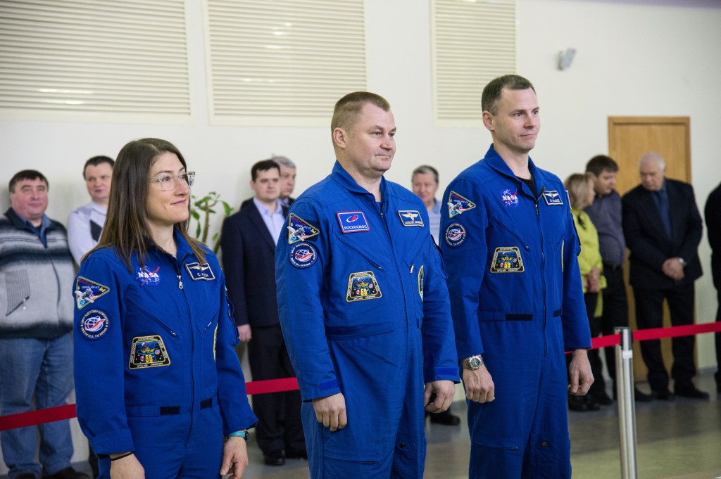 At the Gagarin Cosmonaut Training Center in Star City, Russia, Expedition 59 crew members Christina Koch of NASA (left), Alexey Ovchinin of Roscosmos (center) and Nick Hague of NASA (right) report to Russian space officials Feb. 19 during the first of two days of final pre-launch qualification exams. They will launch March 14, U.S. time, from the Baikonur Cosmodrome in Kazakhstan on the Soyuz MS-12 spacecraft for a six-and-a-half month mission on the International Space Station.