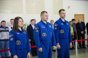 At the Gagarin Cosmonaut Training Center in Star City, Russia, Expedition 59 crew members Christina Koch of NASA (left), Alexey Ovchinin of Roscosmos (center) and Nick Hague of NASA (right) report to Russian space officials Feb. 19 during the first of two days of final pre-launch qualification exams. They will launch March 14, U.S. time, from the Baikonur Cosmodrome in Kazakhstan on the Soyuz MS-12 spacecraft for a six-and-a-half month mission on the International Space Station.