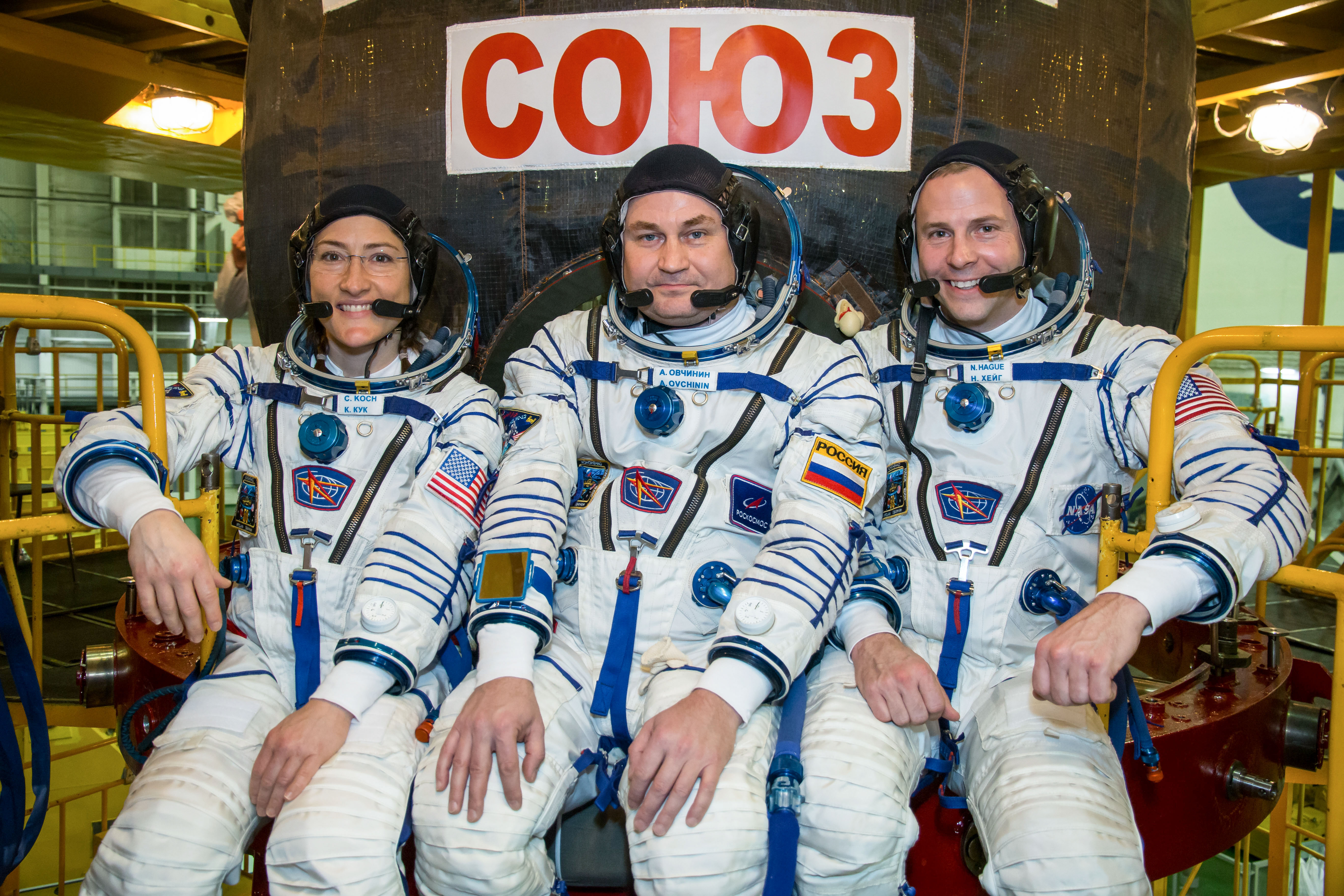 At the Baikonur Cosmodrome in Kazakhstan, Expedition 59 crew members Christina Koch of NASA (left), Alexey Ovchinin of Roscosmos (center) and Nick Hague of NASA (right) pose for pictures in front of their Soyuz MS-12 spacecraft Feb. 27 during pre-launch training. They will launch March 14, U.S. time, on the Soyuz MS-12 spacecraft from the Baikonur Cosmodrome in Kazakhstan for a six-and-a-half month mission on the International Space Station.