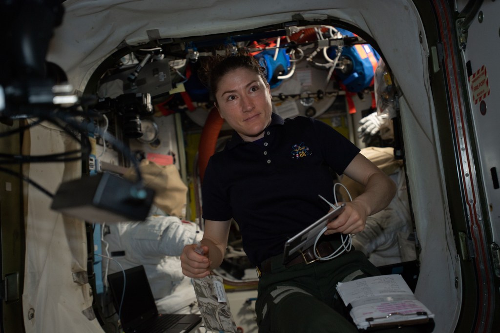 NASA astronaut and Expedition 59 Flight Engineer Christina Koch works on U.S. spacesuits inside the Quest airlock.