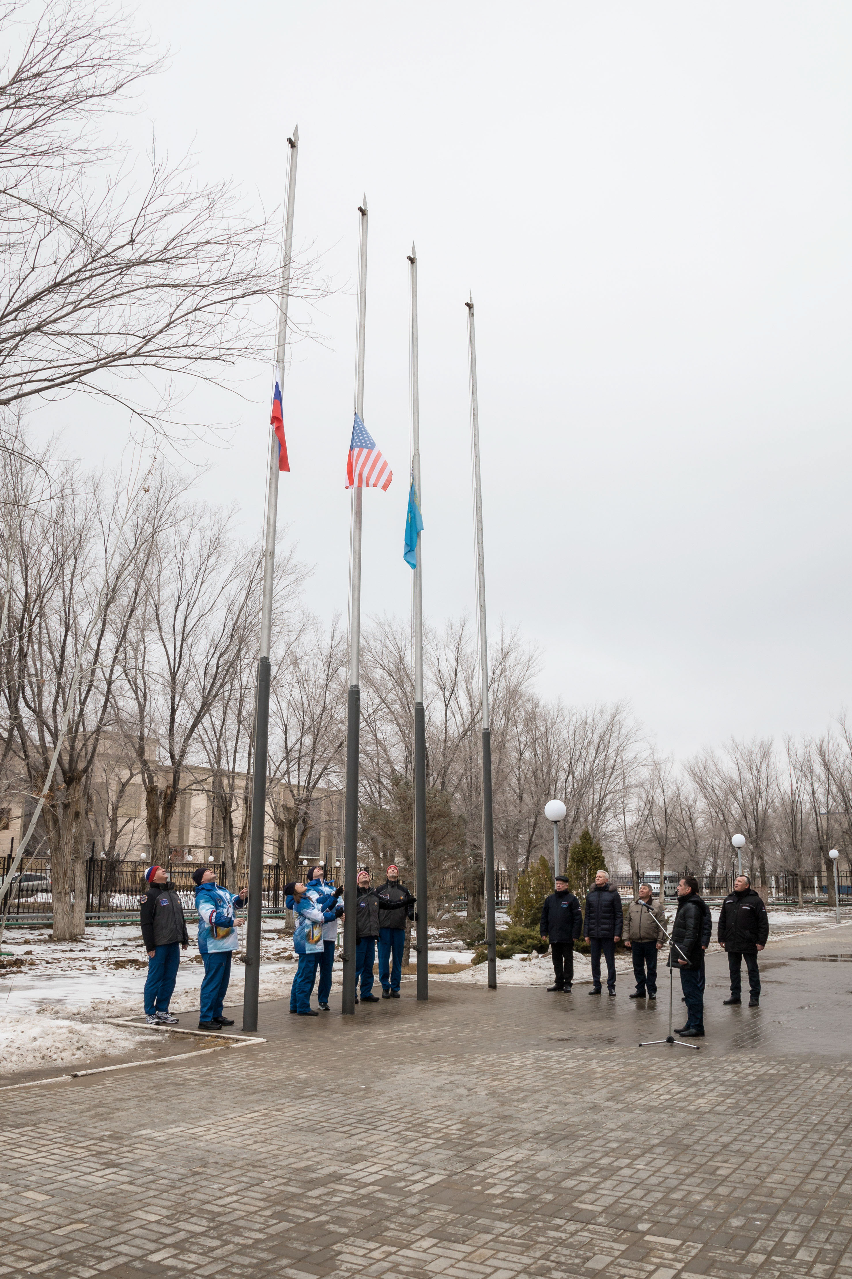 At their Cosmonaut Hotel crew quarters in Baikonur, Kazakhstan, the Expedition 59 prime and backup crew members conduct the traditional raising of the flags of Russia, the U.S. and Kazakhstan Feb. 28 as part of their pre-launch training. From left to right raising the Russian flag are Alexander Skvortsov and Alexey Ovchinin of Roscosmos, raising the U.S. flag are Nick Hague and Christina Koch of NASA and raising the Kazakh flag are Drew Morgan of NASA and Luca Parmitano of the European Space Agency. Hague, Ovchinin and Koch will launch March 14, U.S. time, in the Soyuz MS-12 spacecraft from the Baikonur Cosmodrome in Kazakhstan for a six-and-a-half month mission on the International Space Station.