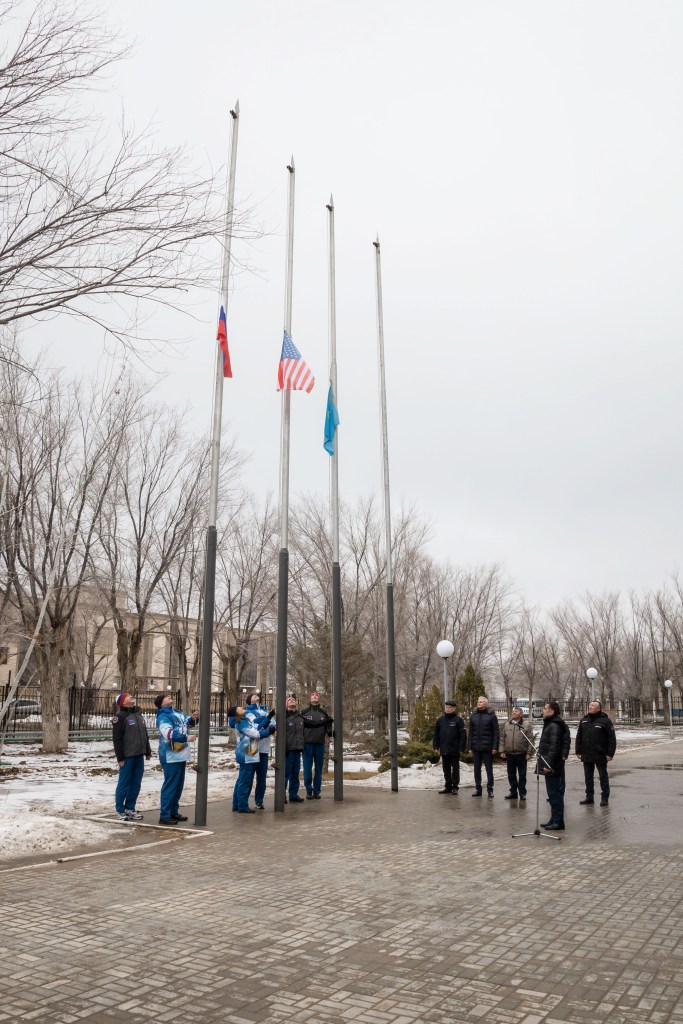 At their Cosmonaut Hotel crew quarters in Baikonur, Kazakhstan, the Expedition 59 prime and backup crew members conduct the traditional raising of the flags of Russia, the U.S. and Kazakhstan Feb. 28 as part of their pre-launch training. From left to right raising the Russian flag are Alexander Skvortsov and Alexey Ovchinin of Roscosmos, raising the U.S. flag are Nick Hague and Christina Koch of NASA and raising the Kazakh flag are Drew Morgan of NASA and Luca Parmitano of the European Space Agency. Hague, Ovchinin and Koch will launch March 14, U.S. time, in the Soyuz MS-12 spacecraft from the Baikonur Cosmodrome in Kazakhstan for a six-and-a-half month mission on the International Space Station.