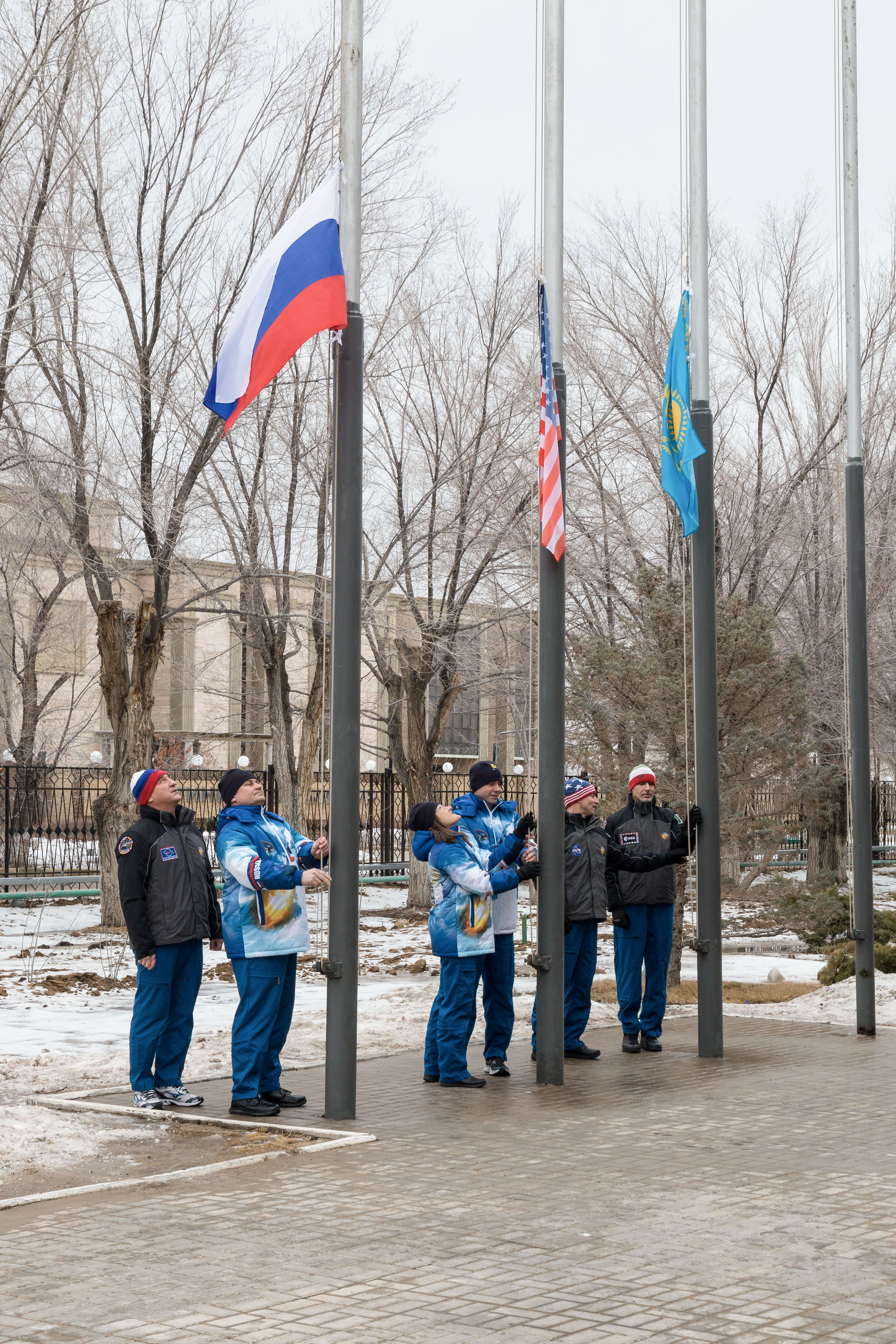 At their Cosmonaut Hotel crew quarters in Baikonur, Kazakhstan, the Expedition 59 prime and backup crew members conduct the traditional raising of the flags of Russia, the U.S. and Kazakhstan Feb. 28 as part of their pre-launch training. From left to right raising the Russian flag are Alexander Skvortsov and Alexey Ovchinin of Roscosmos, raising the U.S. flag are Nick Hague and Christina Koch of NASA and raising the Kazakh flag are Drew Morgan of NASA and Luca Parmitano of the European Space Agency. Hague, Ovchinin and Koch will launch March 14, U.S. time, in the Soyuz MS-12 spacecraft from the Baikonur Cosmodrome in Kazakhstan for a six-and-a-half month mission on the International Space Station.