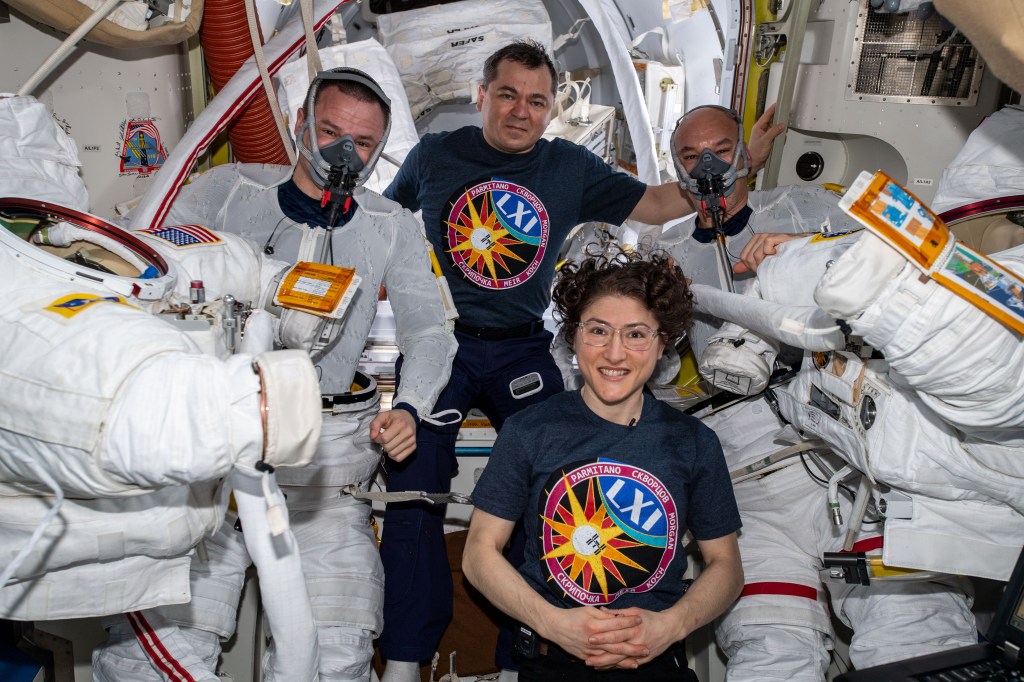Flight Engineers Christina Koch and Oleg Skripochka are pictured assisting spacewalkers Andrew Morgan (left) and Luca Parmitano (right) in the U.S. Quest airlock before they would begin the second spacewalk to repair the Alpha Magnetic Spectrometer's thermal control system.