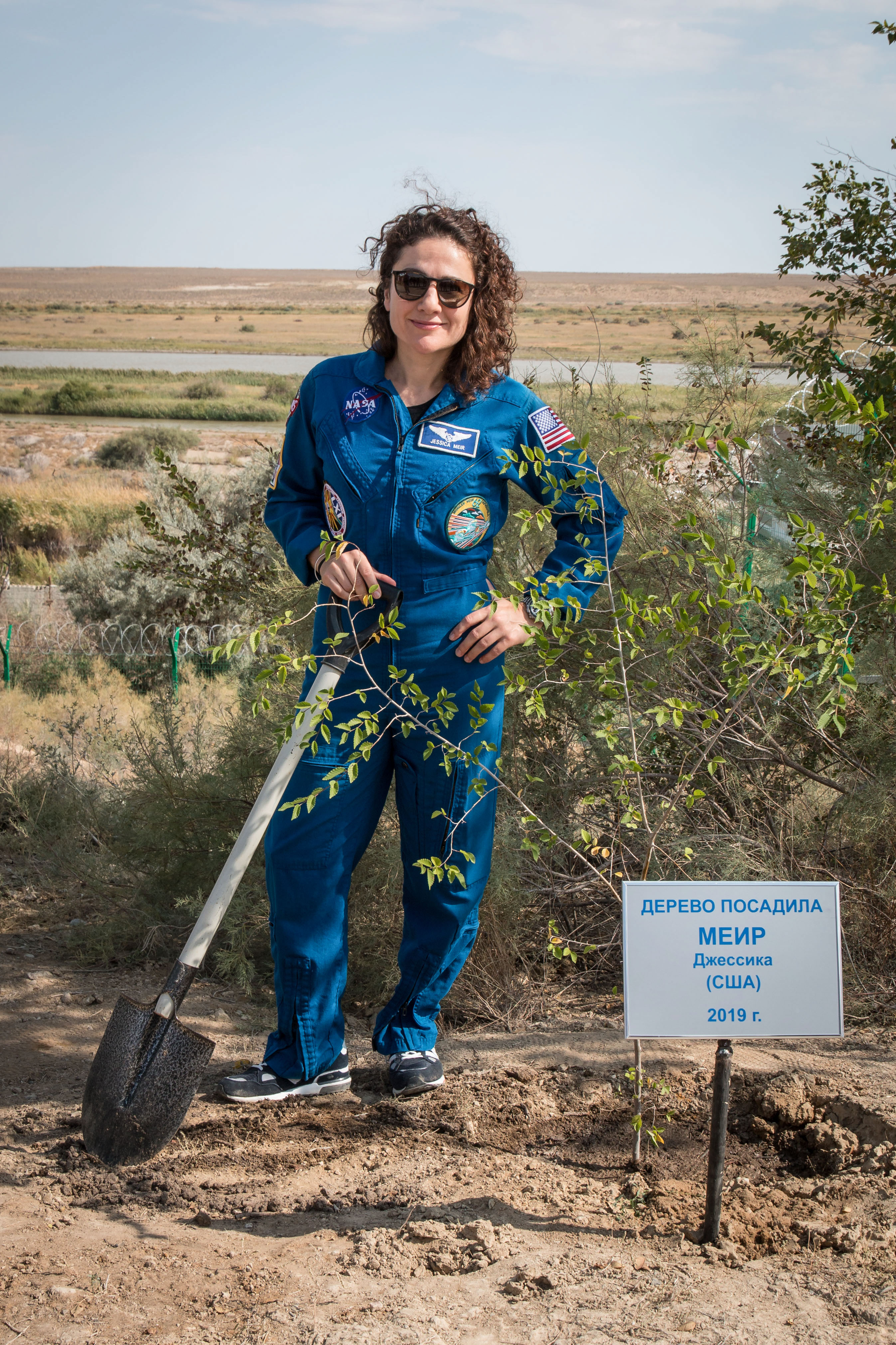 At the Cosmonaut Hotel crew quarters in Baikonur, Kazakhstan, Expedition 61 crewmember Jessica Meir of NASA poses for pictures Sept. 18 after planting a tree in her name in a traditional pre-launch activity. Meir and Expedition 61 crewmember Oleg Skripochka of Roscosmos along with spaceflight participant Hazzaa Ali Almansoori of the United Arab Emirates will launch Sept. 25 from the Baikonur Cosmodrome in Kazakhstan on the Soyuz MS-15 spacecraft for a mission on the International Space Station.