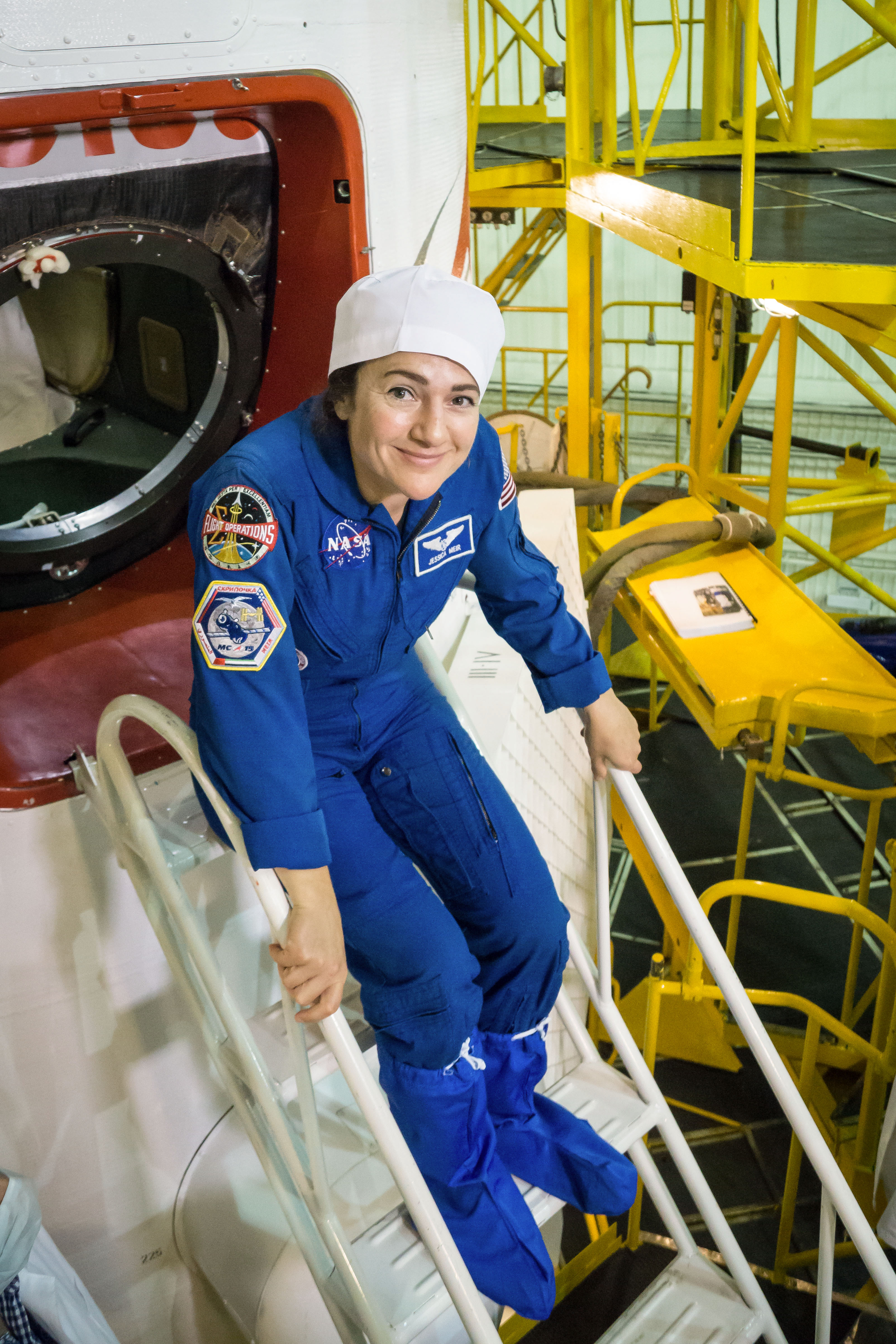 At the Baikonur Cosmodrome in Kazakhstan, Expedition 61 crewmember Jessica Meir of NASA poses for pictures Sept. 20 before inspecting the Soyuz MS-15 spacecraft during final fit check activities. Meir, spaceflight participant Hazzaa Ali Almansoori of the United Arab Emirates and Expedition 61 crewmember Oleg Skripochka of Roscosmos will launch Sept. 25 on the Soyuz MS-15 spacecraft for a mission on the International Space Station.