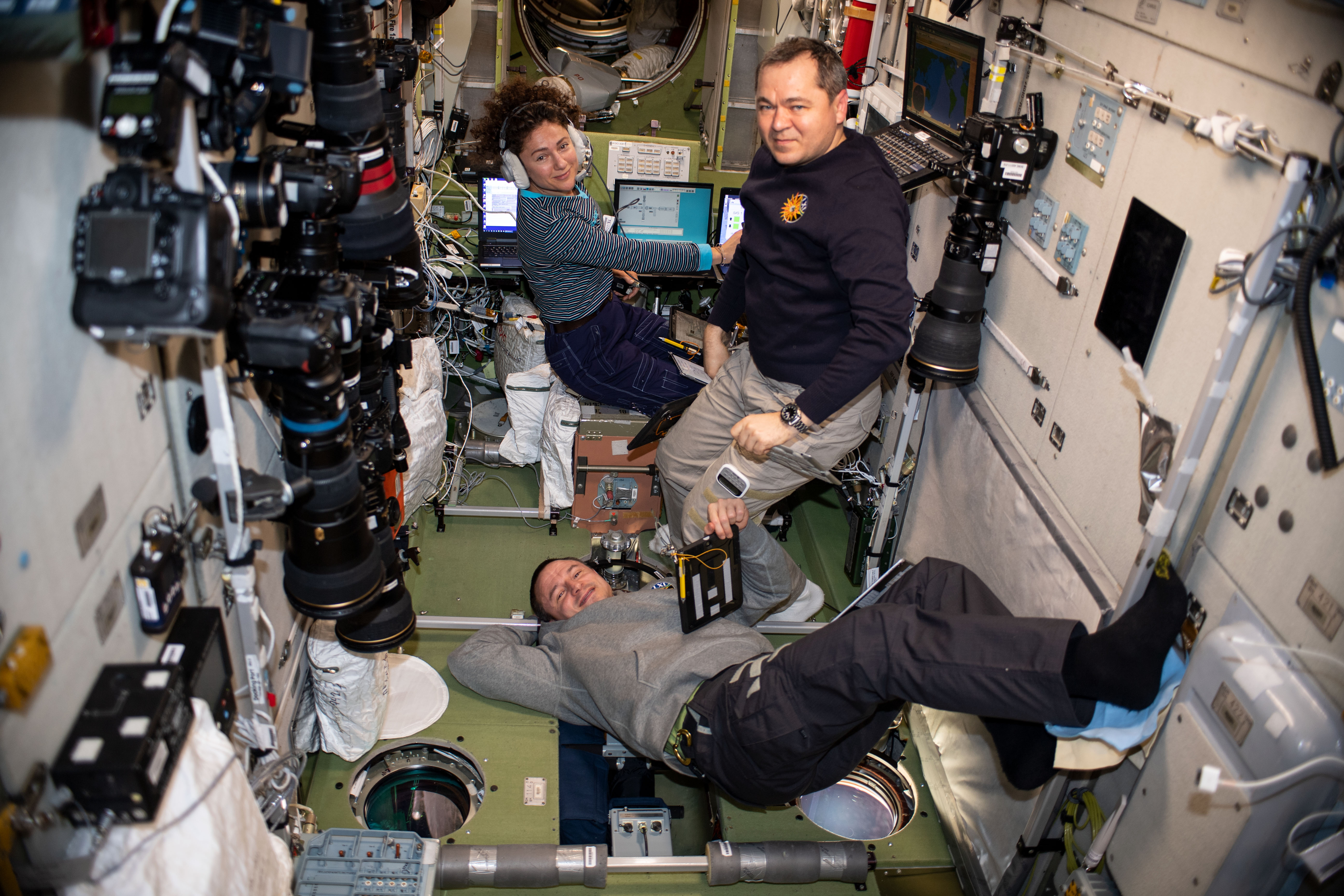 Expedition 61 Flight Engineers (clockwise from bottom) Andrew Morgan and Jessica Meir of NASA and cosmonaut Oleg Skripochka of Roscosmos brush up on their emergency response skills. The three crewmates practiced quickly entering their Soyuz crew ship and simulated emergency undocking and descent procedures in the unlikely event they would need to evacuate the station.