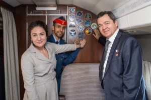 Aboard a Gagarin Cosmonaut Training Center aircraft, Expedition 61 crewmembers Jessica Meir of NASA (left) and Oleg Skripochka of Roscosmos (right) and spaceflight participant Hazzaa Ali Amansoori of the United Arab Emirates (center) point to stickers bearing their mission's insignias Sept. 10 as they flew from their training base in Star City, Russia to their launch site at the Baikonur Cosmodrome in Kazakhstan. They will launch on Sept. 25 from the Baikonur Cosmodrome on the Soyuz MS-15 spacecraft for a mission on the International Space Station.