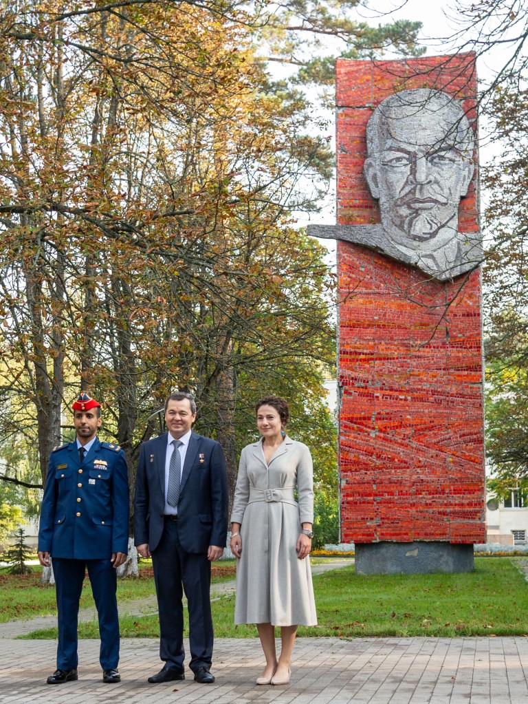 At the Gagarin Cosmonaut Training Center in Star City, Russia, the image of Vladimir Lenin serves as a backdrop as spaceflight participant Hazzaa Ali Almansoori of the United Arab Emirates (left) and Expedition 61 crewmembers Oleg Skripochka of Roscosmos (center) and Jessica Meir of NASA (right) pose for pictures Sept. 10 before traveling to a nearby airfield for a flight to their launch site at the Baikonur Cosmodrome in Kazakhstan. They will launch on Sept. 25 from the Baikonur Cosmodrome on the Soyuz MS-15 spacecraft for a mission on the International Space Station.