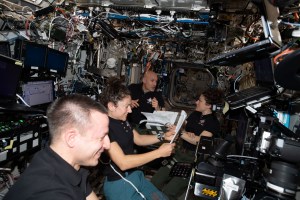 Expedition 61 crewmembers (from left) Andrew Morgan, Jessica Meir, Luca Parmitano and Christina Koch gather inside the U.S. Destiny laboratory module to review spacewalk procedures for the complex repair work planned for the International Space Station's cosmic particle detector, the Alpha Magnetic Spectrometer.