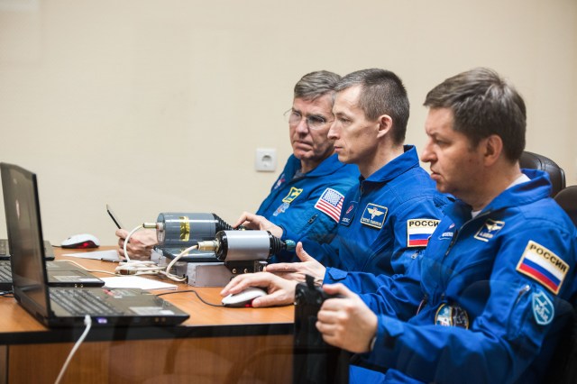 At the Cosmonaut Hotel crew quarters in Baikonur, Kazakhstan, Expedition 63 backup crewmembers Steve Bowen of NASA (left) and Sergey Ryzhikov (center) and Andrei Babkin (right) of Roscosmos practice rendezvous techniques on a laptop simulator April 1. They are the backups to the prime crew, Chris Cassidy of NASA and Anatoly Ivanishin and Ivan Vagner of Roscosmos, who will launch April 9 on the Soyuz MS-16 spacecraft from the Baikonur Cosmodrome in Kazakhstan for a six-and-a-half month mission on the International Space Station.