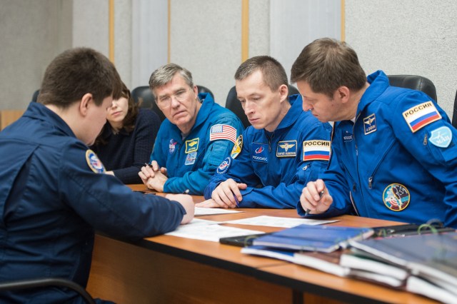 At the Cosmonaut Hotel crew quarters in Baikonur, Kazakhstan, Expedition 63 backup crewmembers Steve Bowen of NASA (left) and Sergey Ryzhikov (center) and Andrei Babkin (right) of Roscosmos review launch procedures with trainers April 1. They are the backups to the prime crew, Chris Cassidy of NASA and Anatoly Ivanishin and Ivan Vagner of Roscosmos, who will launch April 9 on the Soyuz MS-16 spacecraft from the Baikonur Cosmodrome in Kazakhstan for a six-and-a-half month mission on the International Space Station.