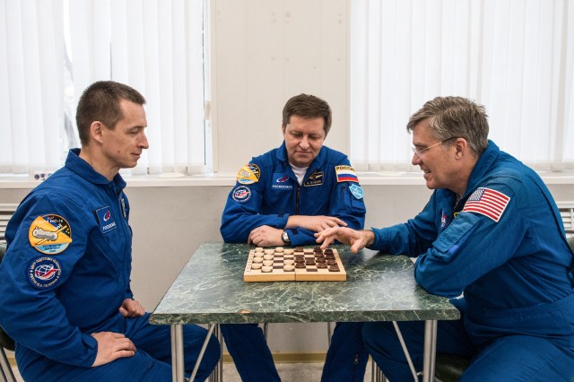 At the Cosmonaut Hotel crew quarters in Baikonur, Kazakhstan, Expedition 63 backup crewmembers Sergey Ryzhikov (left) and Andrei Babkin (center) of Roscosmos and Steve Bowen of NASA (right) share a game of chess April 1. They are the backups to the prime crew, Chris Cassidy of NASA and Anatoly Ivanishin and Ivan Vagner of Roscosmos, who will launch April 9 on the Soyuz MS-16 spacecraft from the Baikonur Cosmodrome in Kazakhstan for a six-and-a-half month mission on the International Space Station.