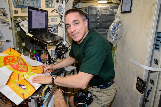 NASA astronaut and Expedition 63 Commander Chris Cassidy works inside the International Space Station's Zvezda service module preparing for an event commemorating Russian space activities.