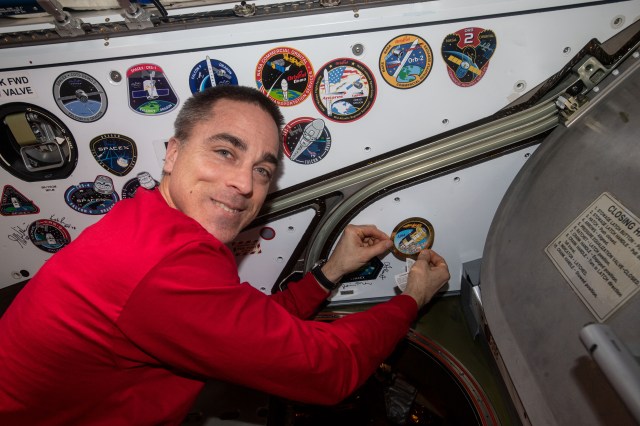 NASA astronaut and Expedition 63 Commander Chris Cassidy applies a mission sticker to the vestibule in between the U.S. Harmony module and JAXA's (Japan Aerospace Exploration Agency) H-II Transfer Vehicle-9 (HTV-9). The HTV-9 would later be uninstalled from Harmony before being released it into Earth orbit that day completing an 85-day cargo mission.